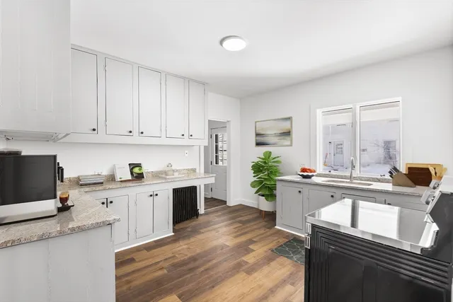 a kitchen with a sink stove and cabinets