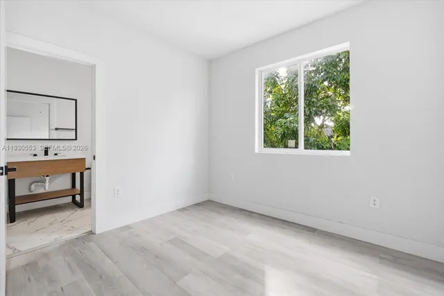 an empty room with a window and outdoor view