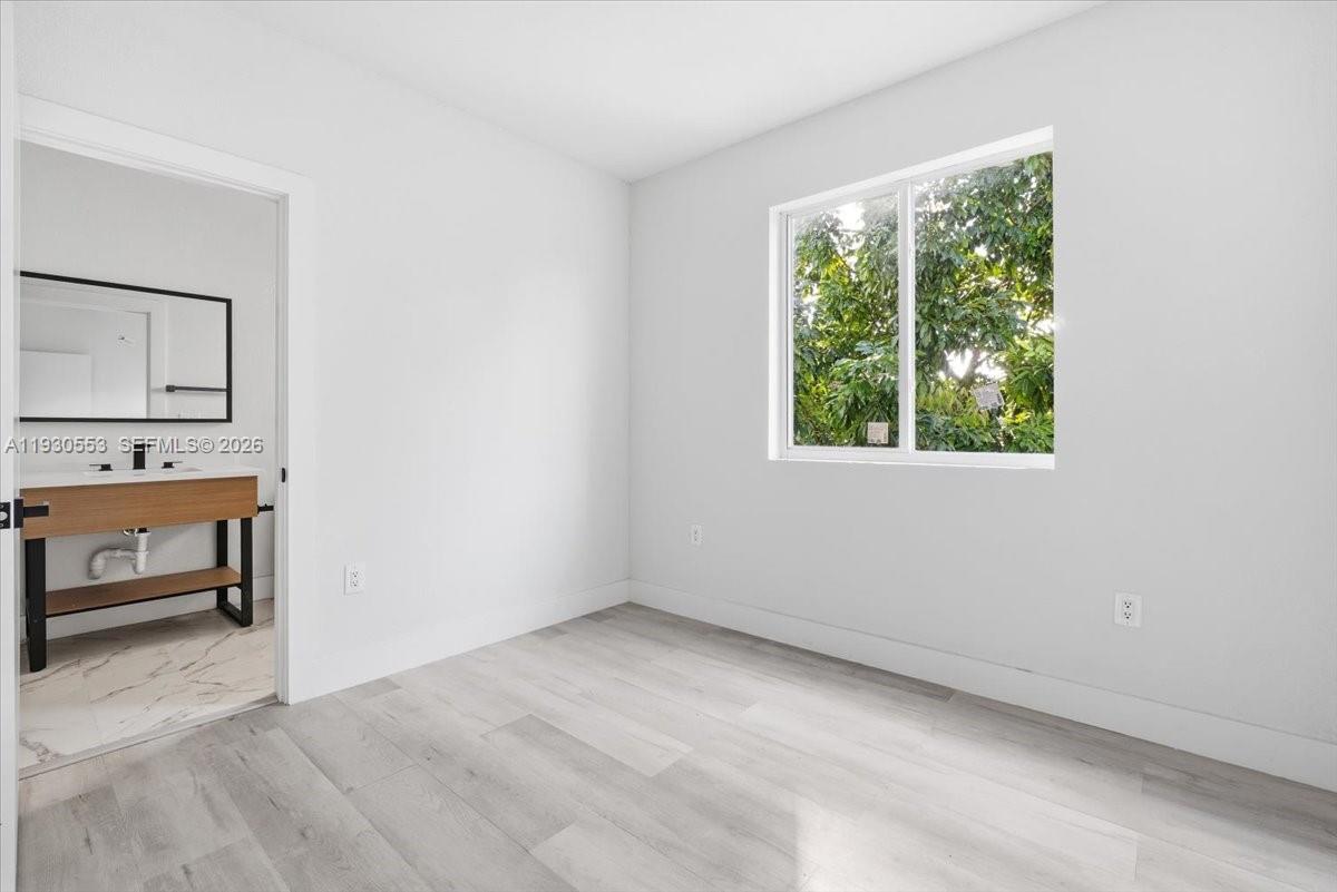 1126 Northwest 28th Street, Unit 1126 Miami, FL 33127 - Photo 15 of 26 an empty room with a window and outdoor view