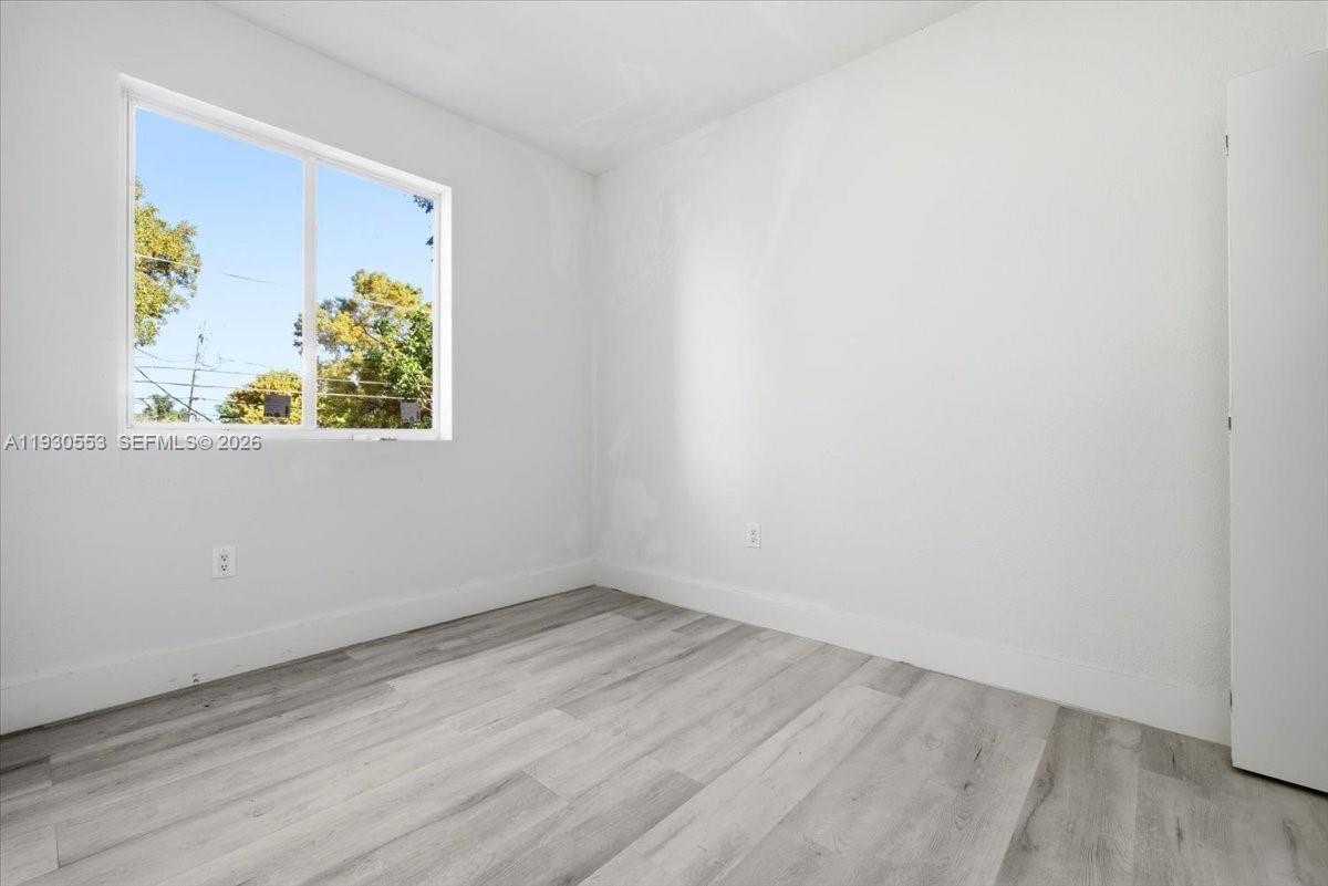 1126 Northwest 28th Street, Unit 1126 Miami, FL 33127 - Photo 17 of 26 an empty room with a window