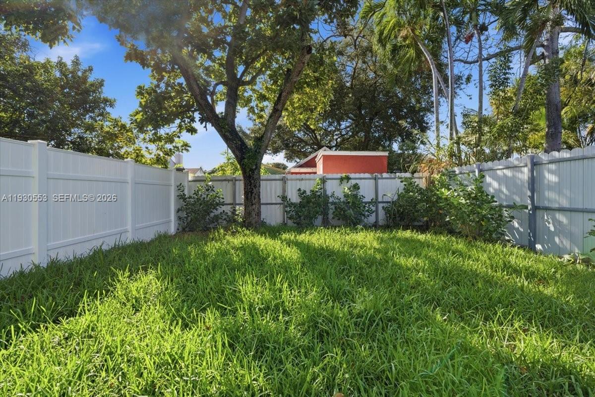 1126 Northwest 28th Street, Unit 1126 Miami, FL 33127 - Photo 19 of 26 a backyard of a house with lots of green space