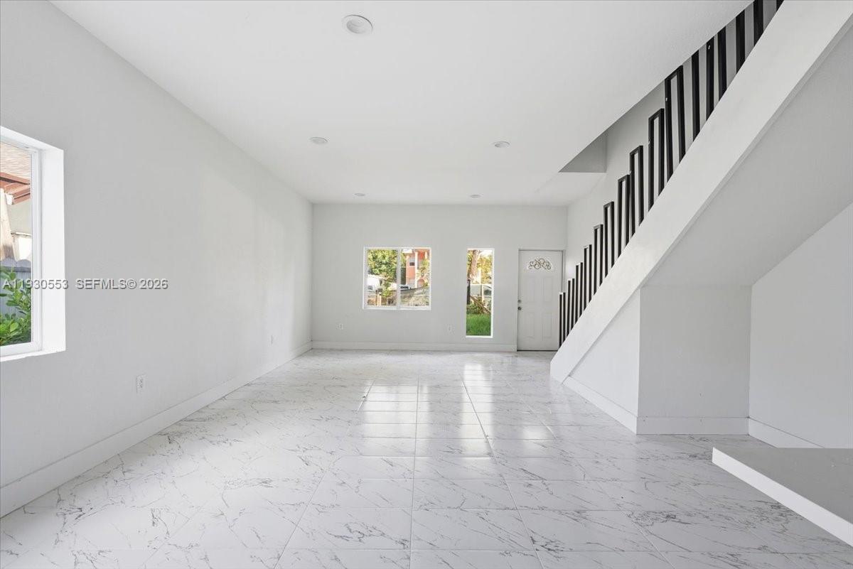 1126 Northwest 28th Street, Unit 1126 Miami, FL 33127 - Photo 2 of 26 a view of entryway and hall with wooden floor