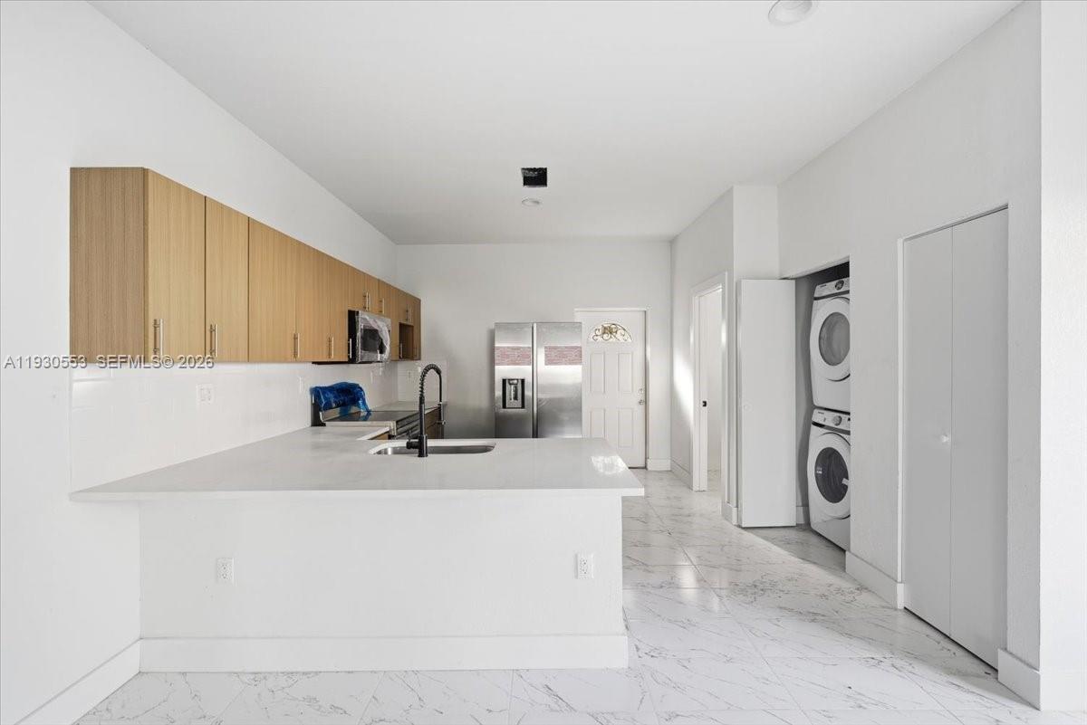 1126 Northwest 28th Street, Unit 1126 Miami, FL 33127 - Photo 22 of 26 a bathroom with a sink a mirror and shower