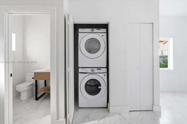 a utility room with sink dryer and washer