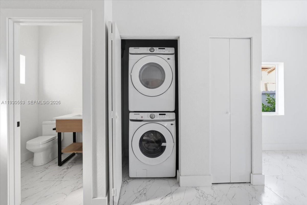 1126 Northwest 28th Street, Unit 1126 Miami, FL 33127 - Photo 25 of 26 a utility room with sink dryer and washer