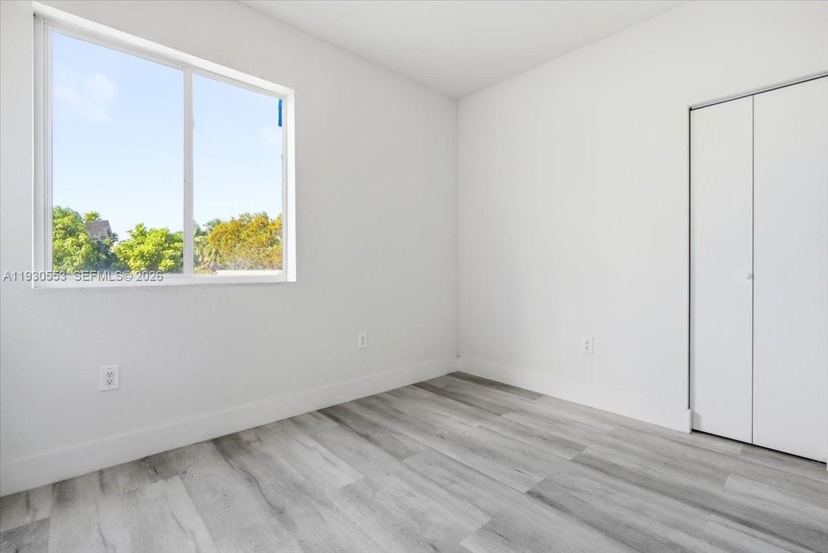 1126 Northwest 28th Street, Unit 1126 Miami, FL 33127 - Photo 7 of 26 an empty room with a window