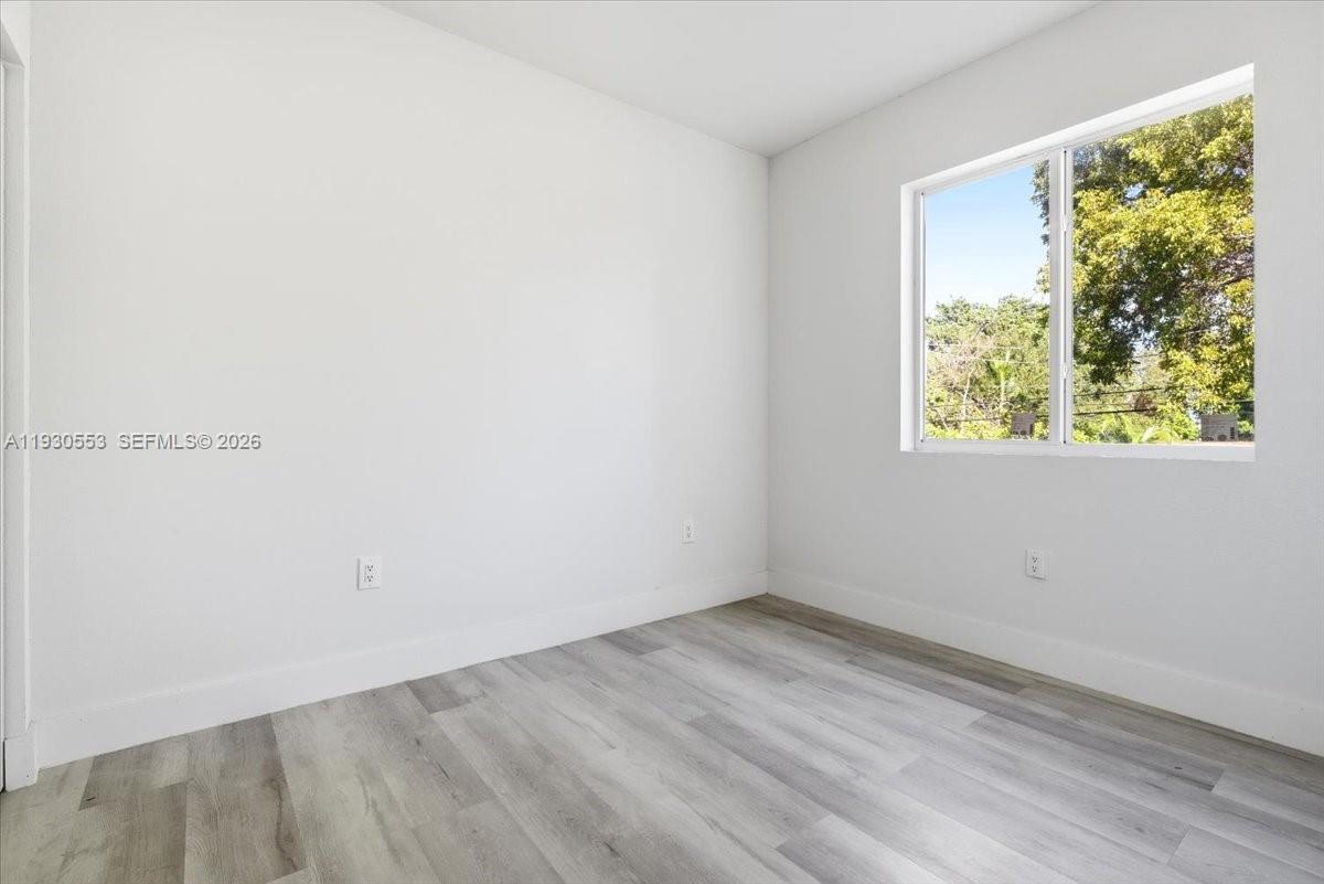 1126 Northwest 28th Street, Unit 1126 Miami, FL 33127 - Photo 8 of 26 an empty room with a window