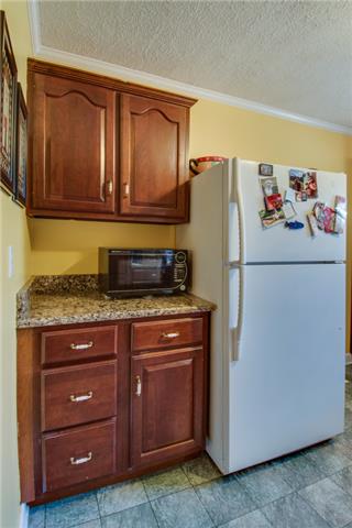 313 Gates Road Goodlettsville, TN 37072 - Photo 7 of 19 Additional countertop and cabinetry is available adjacent to the refrigerator for even more storage space.