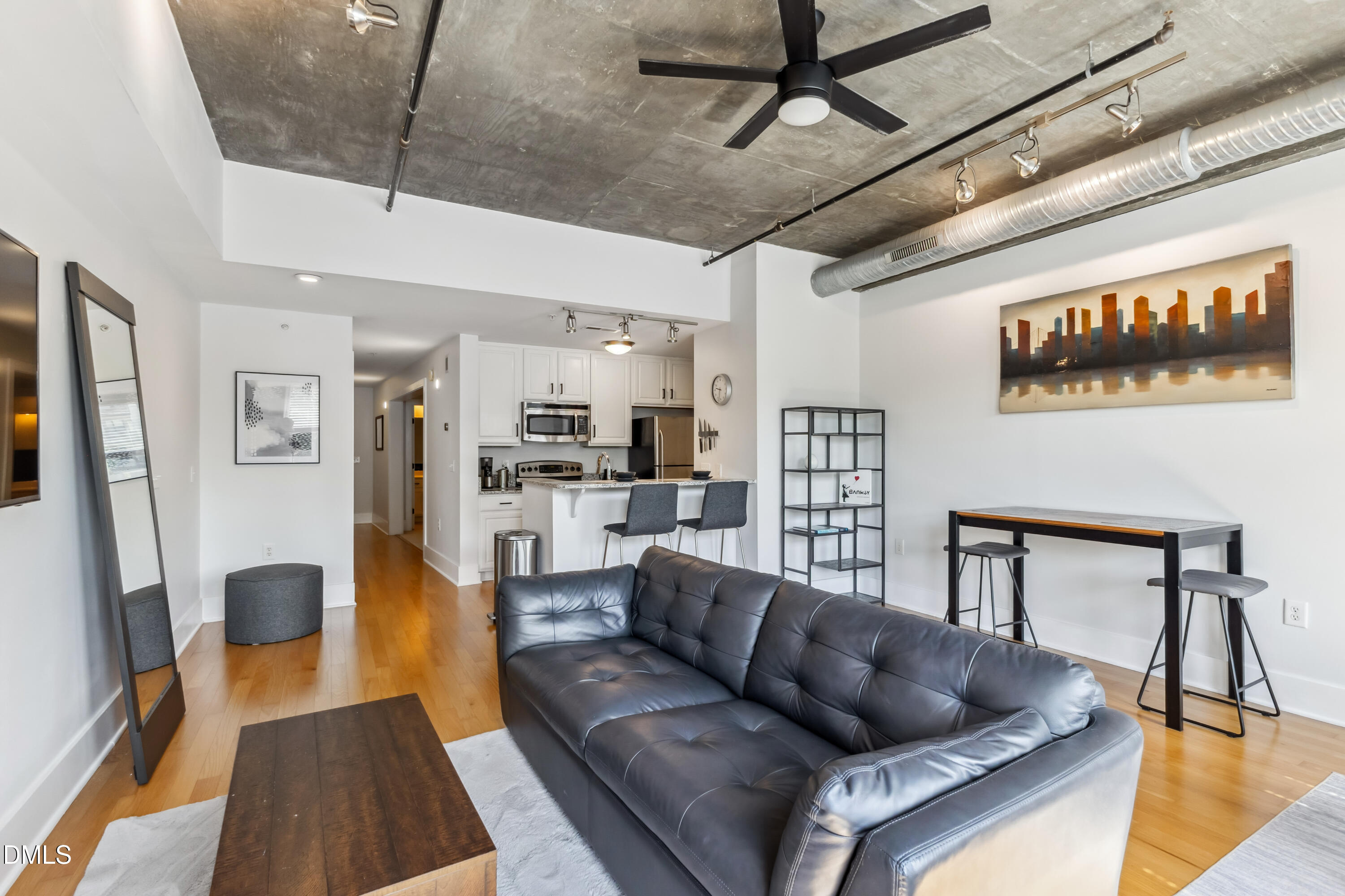a living room with furniture and a wooden floor