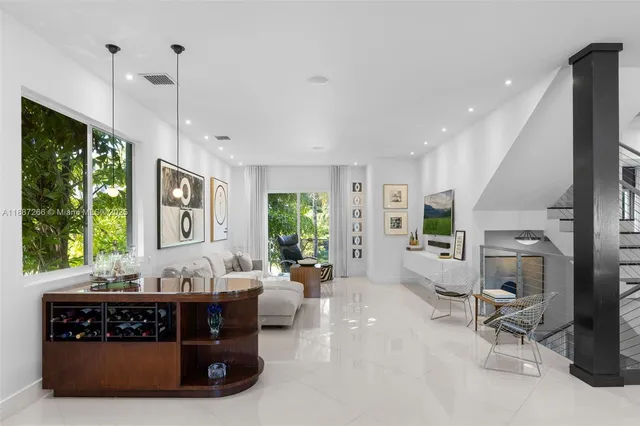 a living room with furniture and large windows