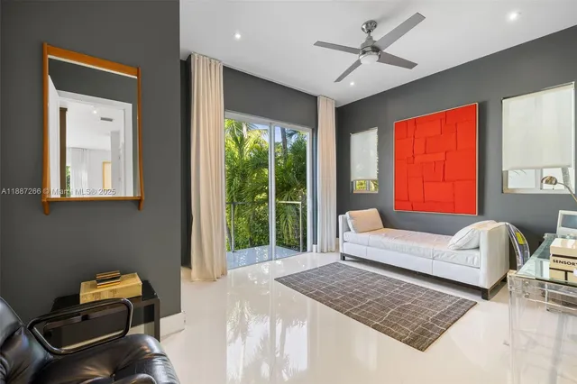 a bedroom with a bed a couch and a window