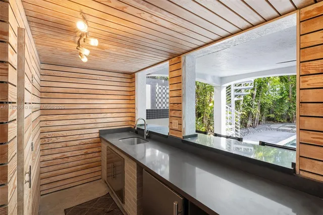 a kitchen with a large window sink and cabinets
