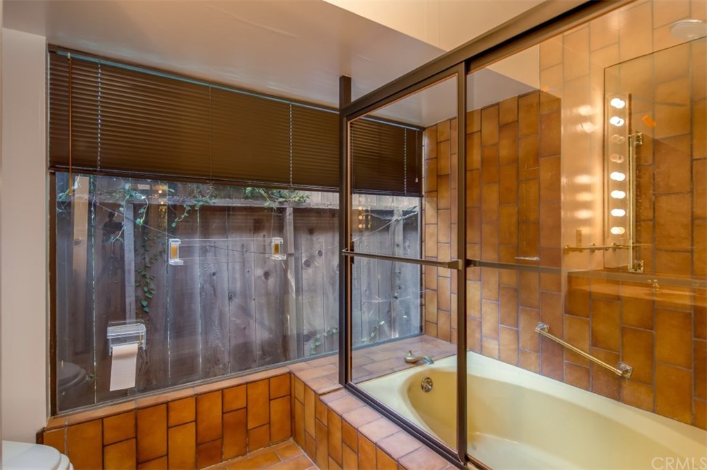 1844 Upper Rim Rock Road Laguna Beach, CA 92651 - Photo 24 of 38 a bathroom with a bathtub and shower