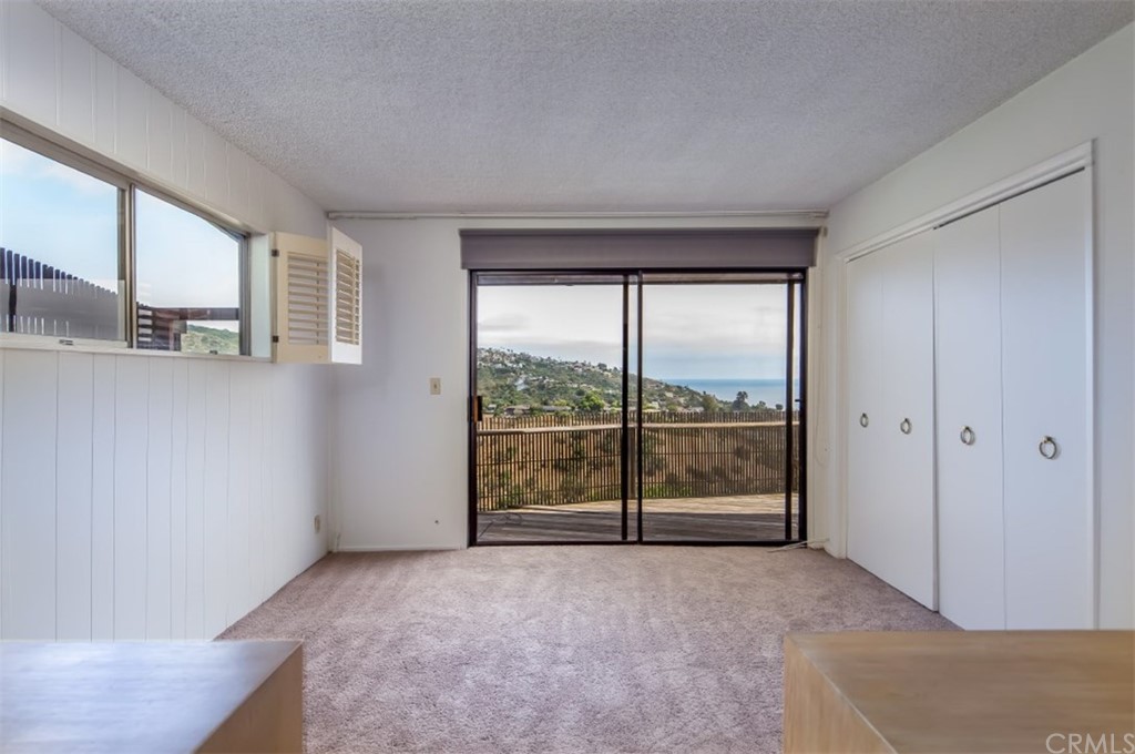 1844 Upper Rim Rock Road Laguna Beach, CA 92651 - Photo 25 of 38 an empty room with large windows