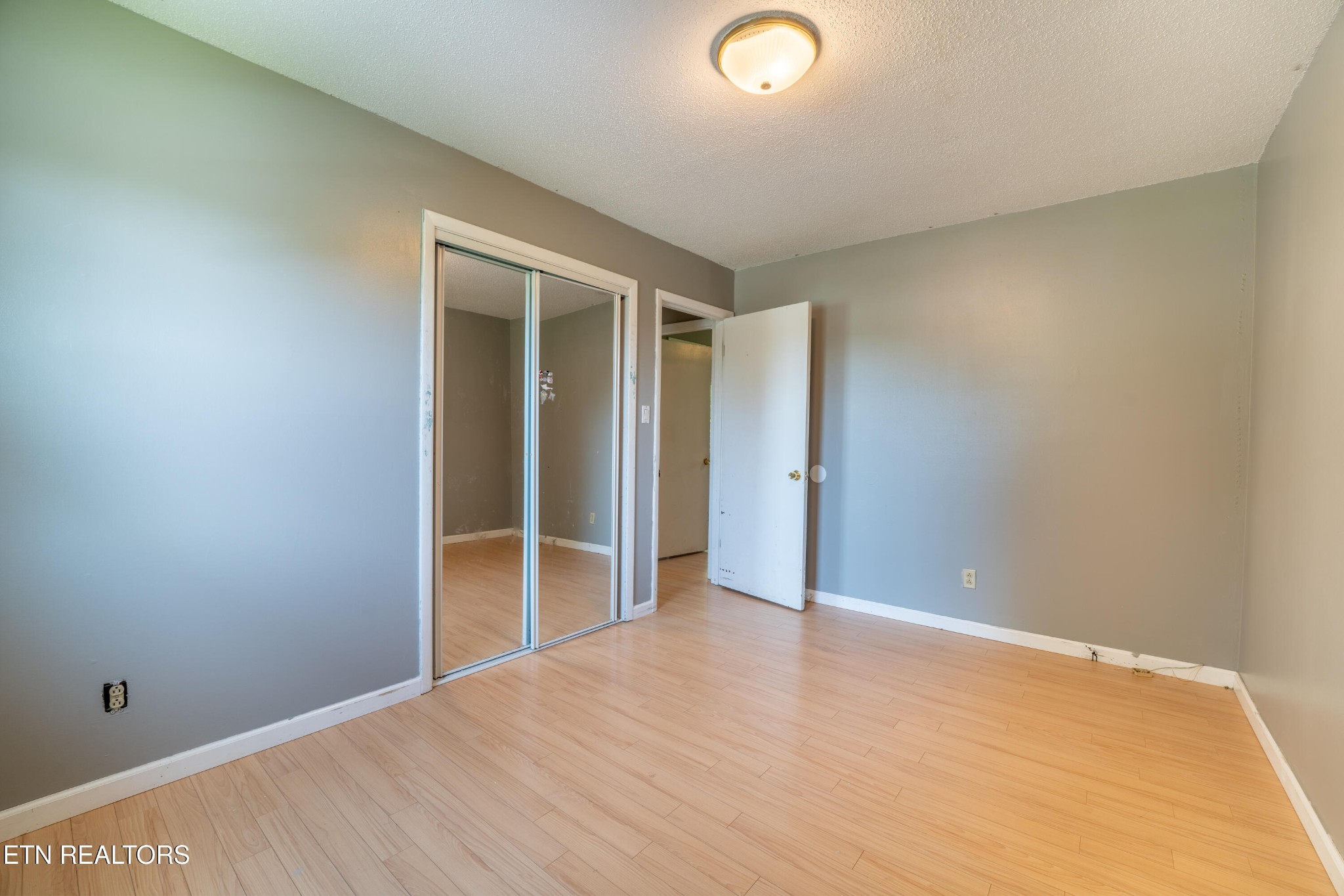 7725 Cranley Road Powell, TN 37849 - Photo 17 of 43 an empty room with wooden floor and entrance