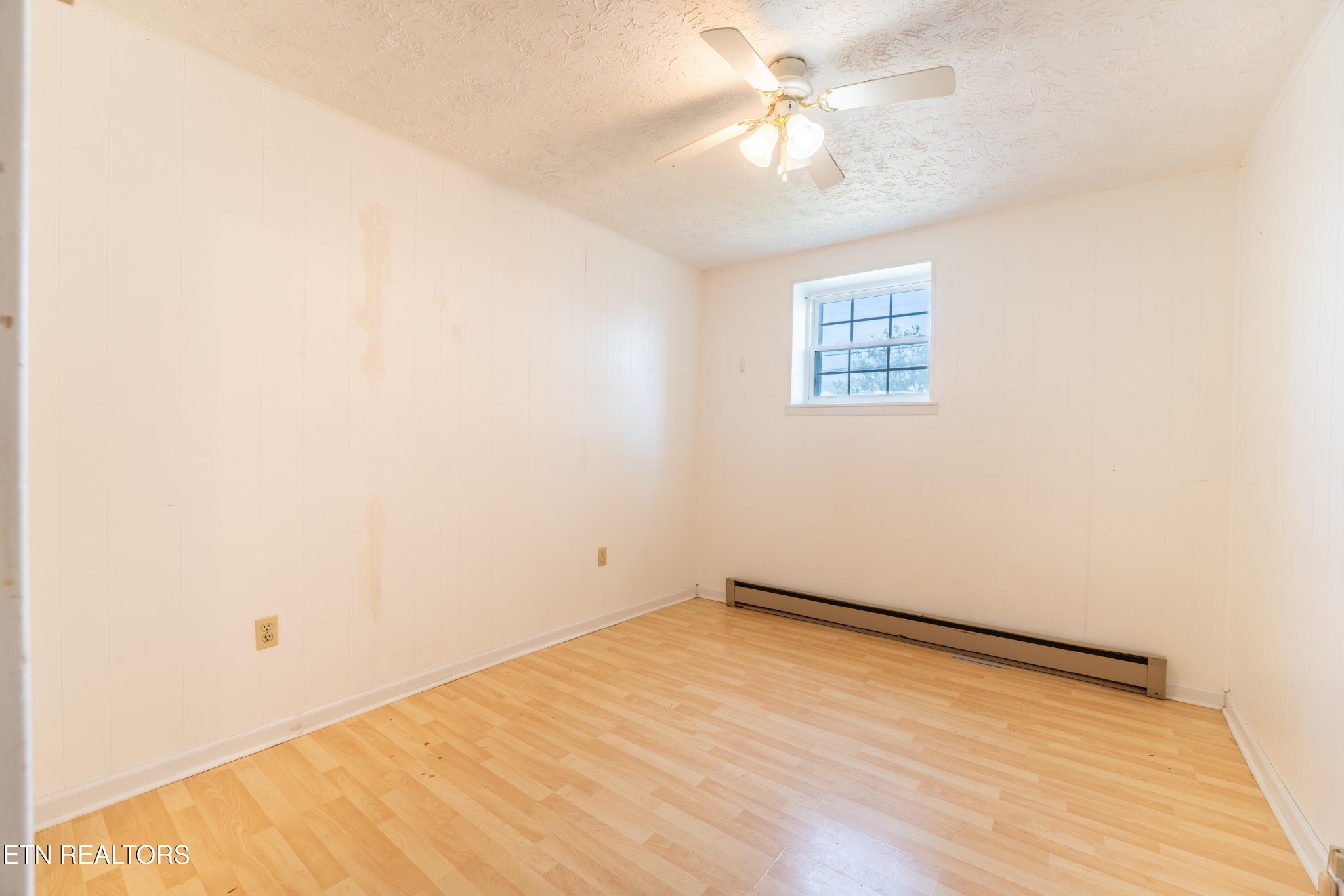 7725 Cranley Road Powell, TN 37849 - Photo 23 of 43 an empty room with a ceiling fan and wooden floor