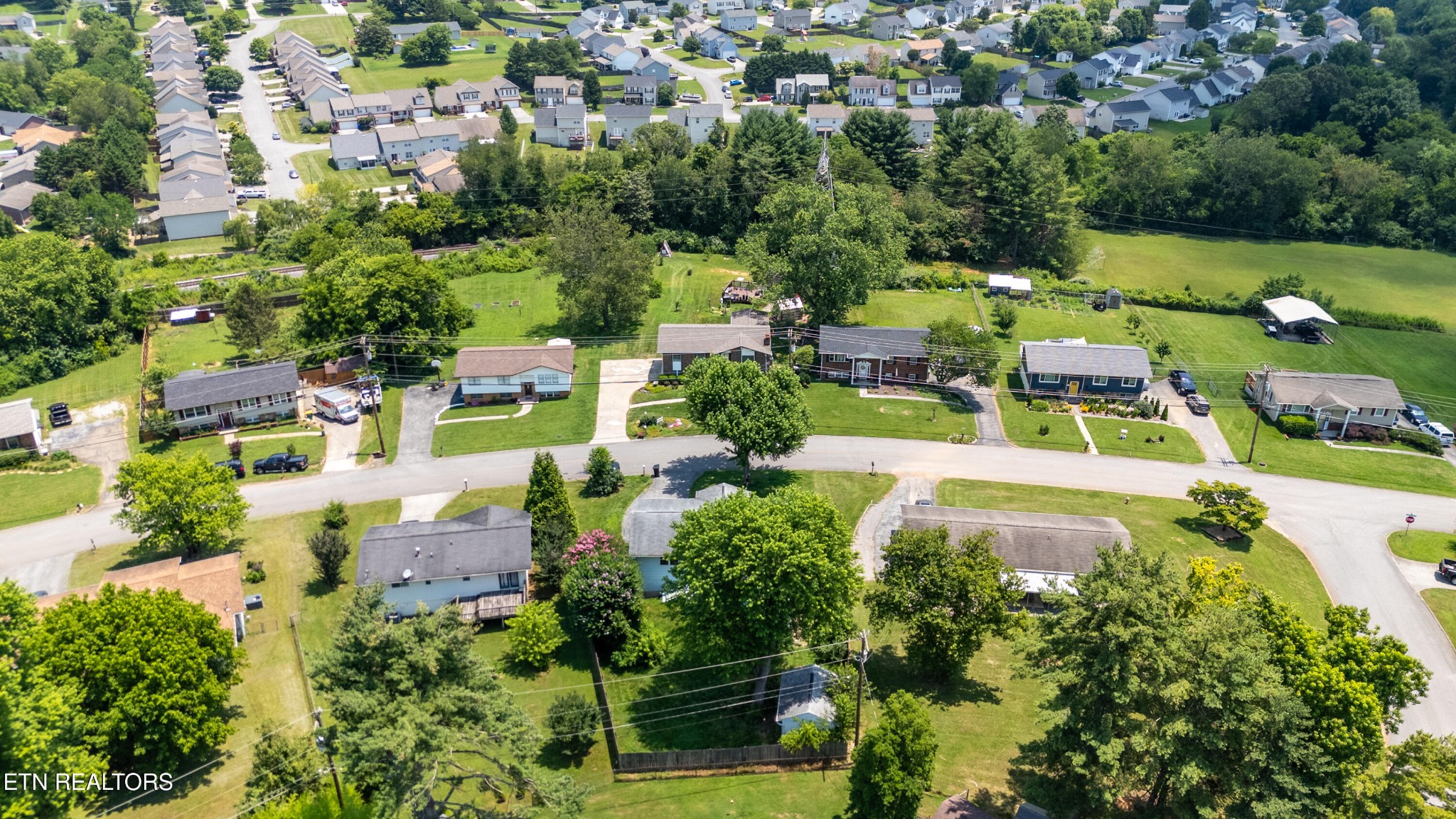 7725 Cranley Road Powell, TN 37849 - Photo 40 of 43 an aerial view of a house with swimming pool a yard and lake view