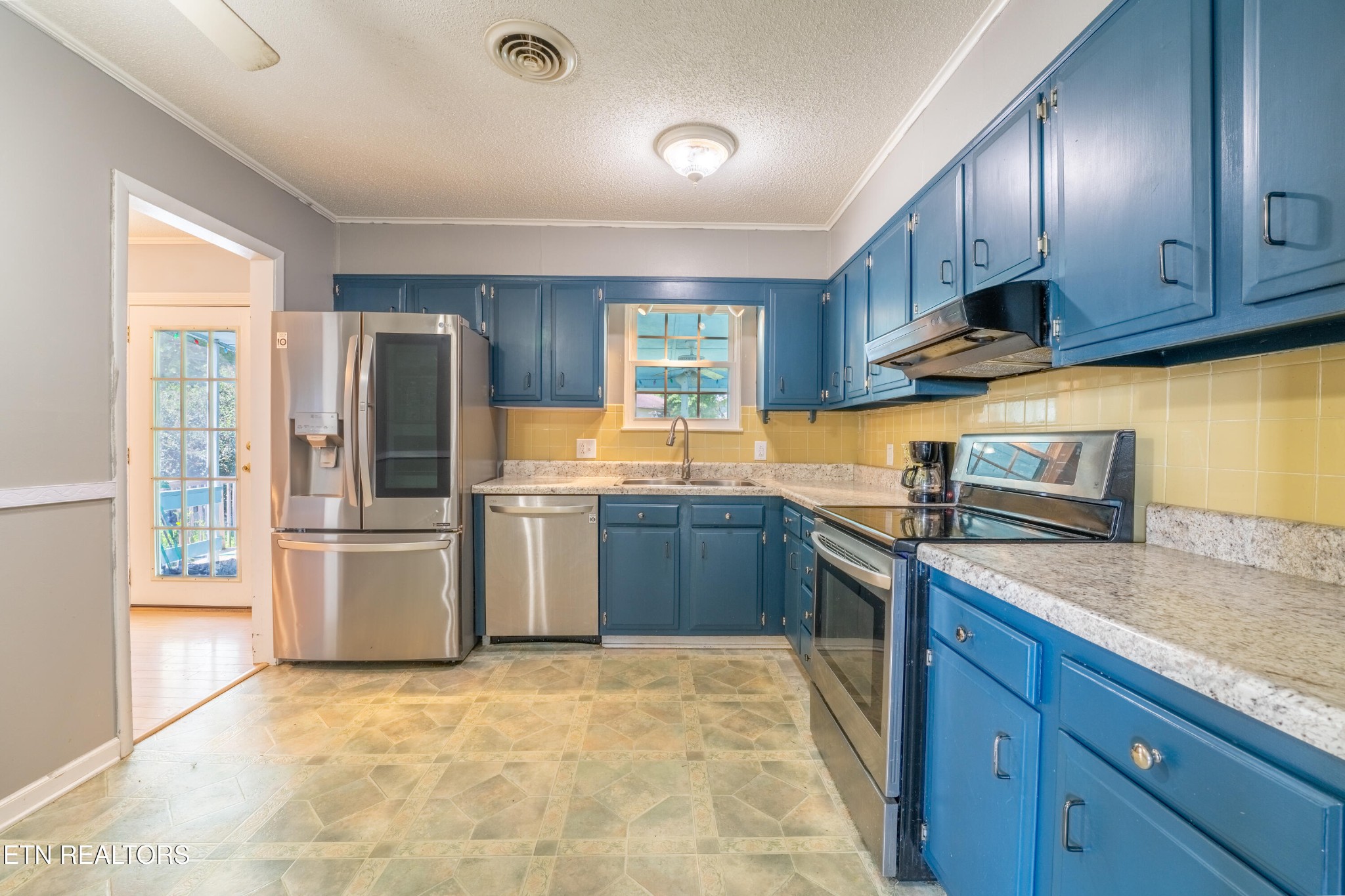 7725 Cranley Road Powell, TN 37849 - Photo 9 of 43 a kitchen with stainless steel appliances granite countertop a refrigerator stove and sink