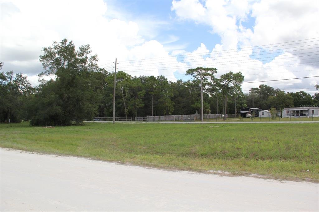 5140 Miami Street Brooksville, FL 34604 - Photo 3 of 6 a view of a golf course with a lake
