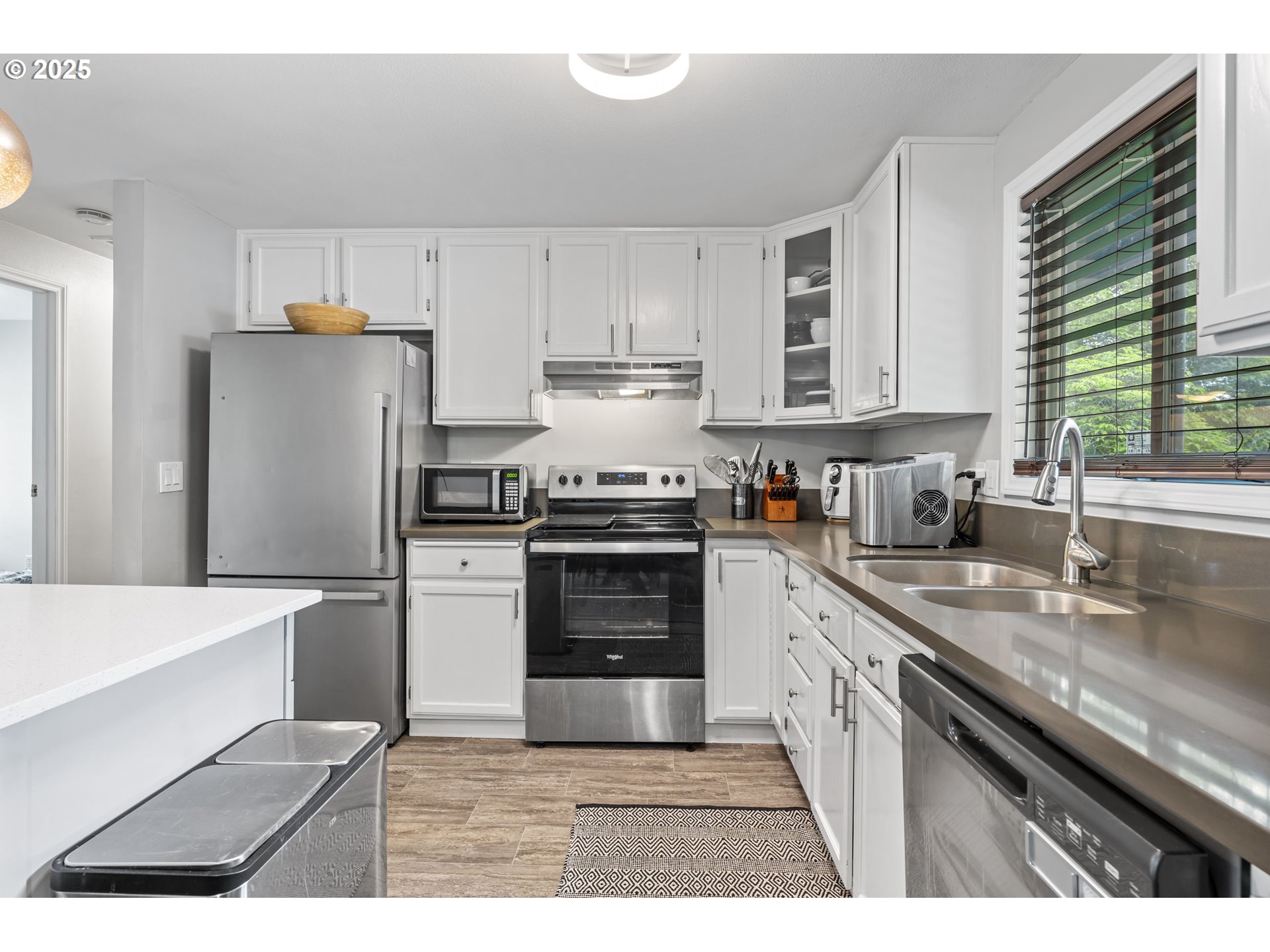 1245 Southeast 211th Avenue Gresham, OR 97030 - Photo 11 of 36 a kitchen with a refrigerator and a sink