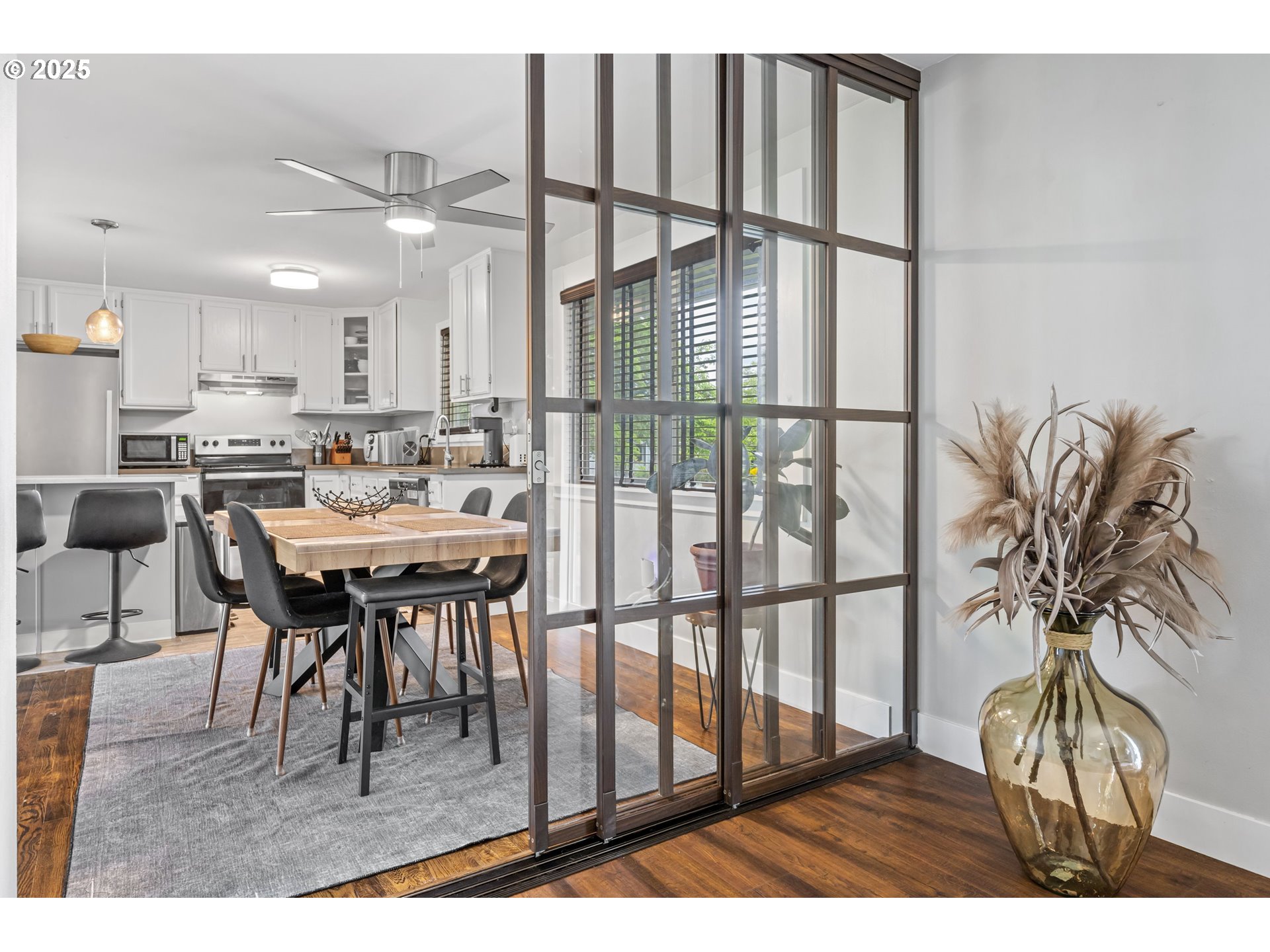 1245 Southeast 211th Avenue Gresham, OR 97030 - Photo 16 of 36 a dining room with furniture and a floor to ceiling window