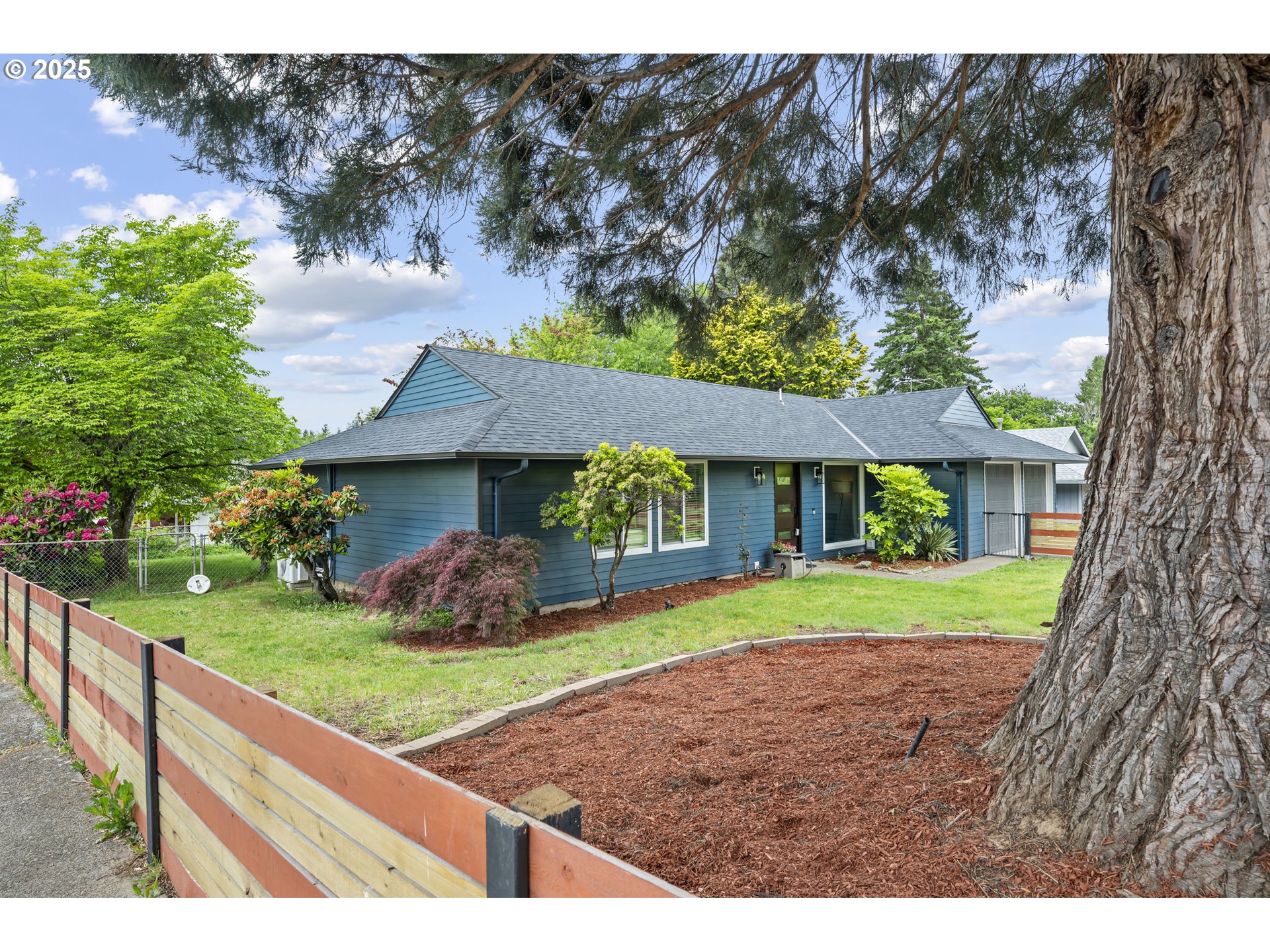 1245 Southeast 211th Avenue Gresham, OR 97030 - Photo 2 of 36 a front view of a house with garden