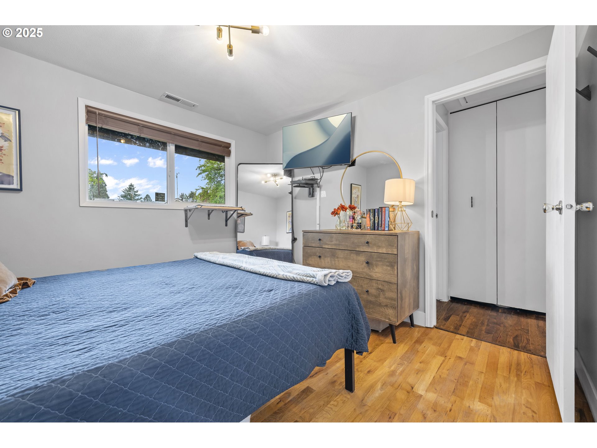 1245 Southeast 211th Avenue Gresham, OR 97030 - Photo 23 of 36 a bed room with a bed mirror and a window