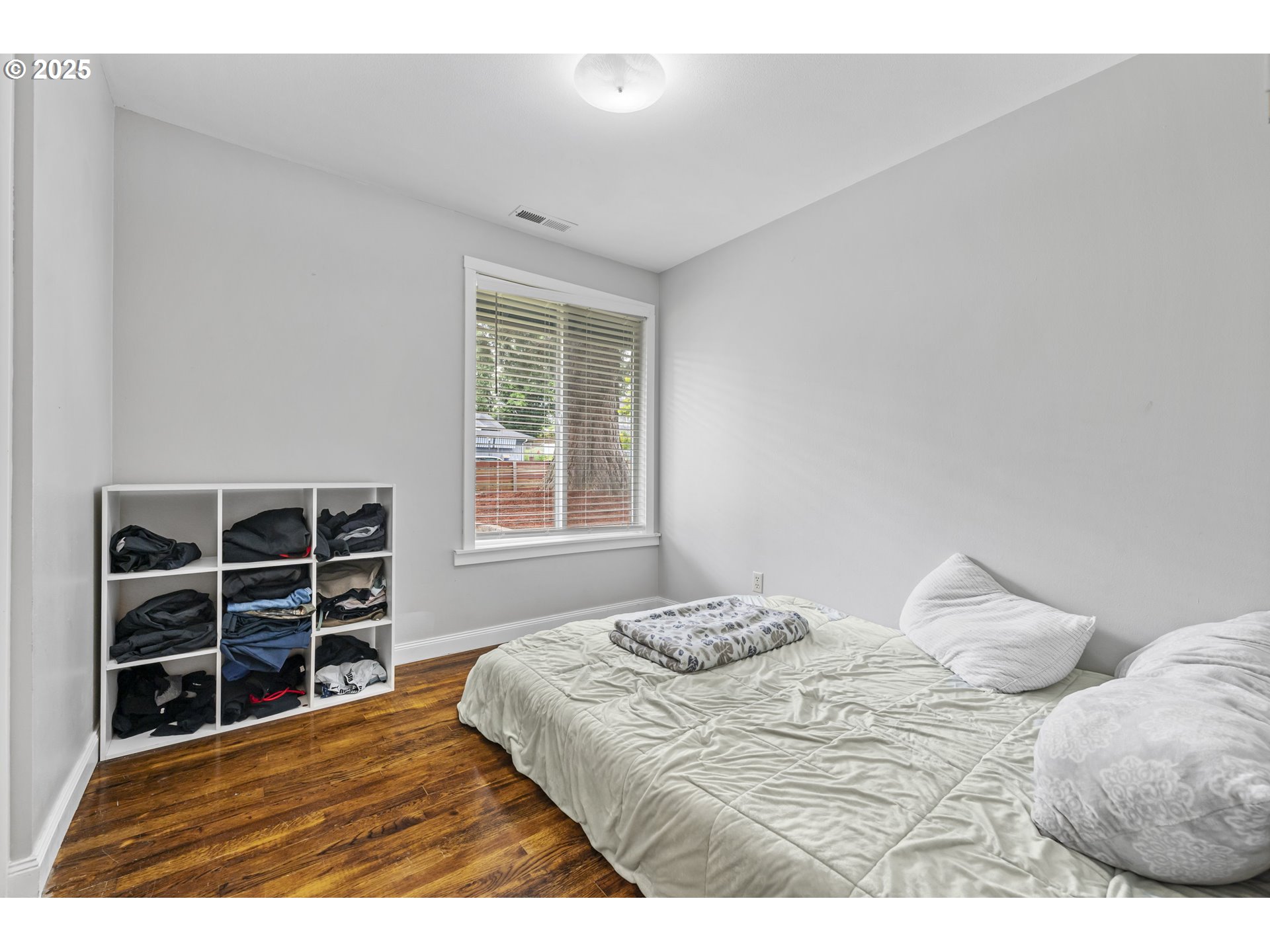 1245 Southeast 211th Avenue Gresham, OR 97030 - Photo 27 of 36 a bedroom with a bed and closet with wooden floor