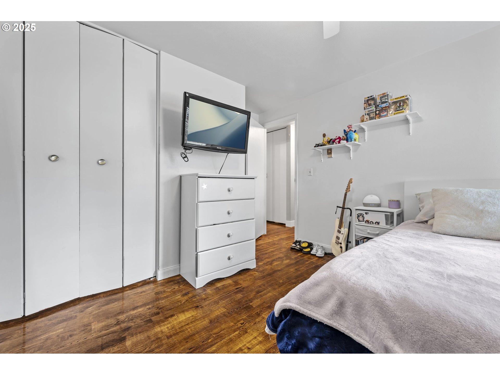 1245 Southeast 211th Avenue Gresham, OR 97030 - Photo 29 of 36 a bedroom with a bed and a flat screen tv