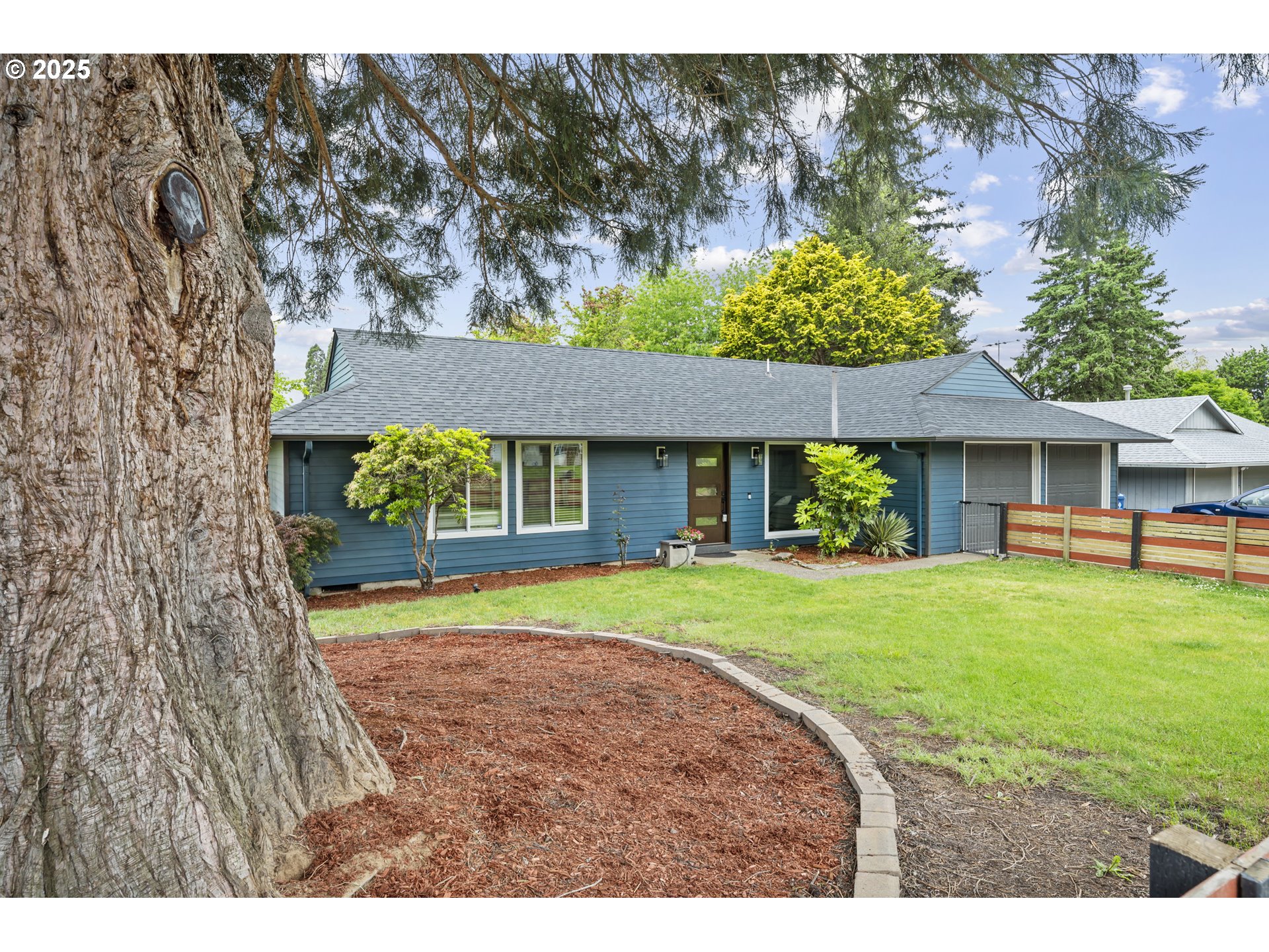 1245 Southeast 211th Avenue Gresham, OR 97030 - Photo 3 of 36 a front view of a house with a yard and porch