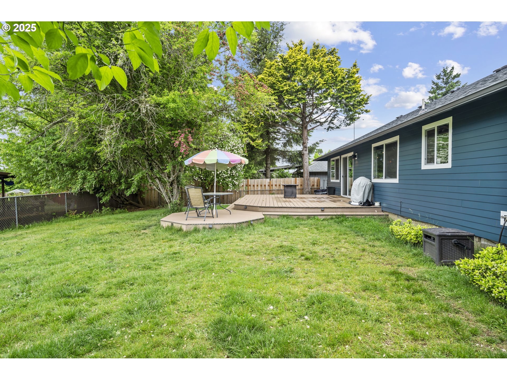 1245 Southeast 211th Avenue Gresham, OR 97030 - Photo 34 of 36 a backyard of a house with table and chairs