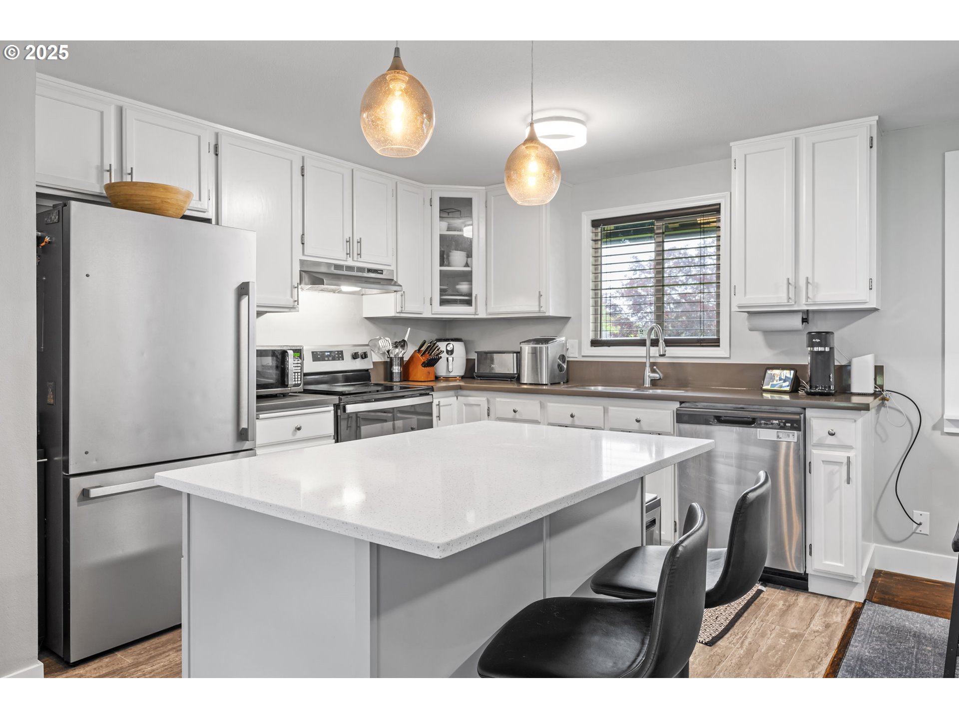 1245 Southeast 211th Avenue Gresham, OR 97030 - Photo 9 of 36 a kitchen with stainless steel appliances a refrigerator sink and cabinets