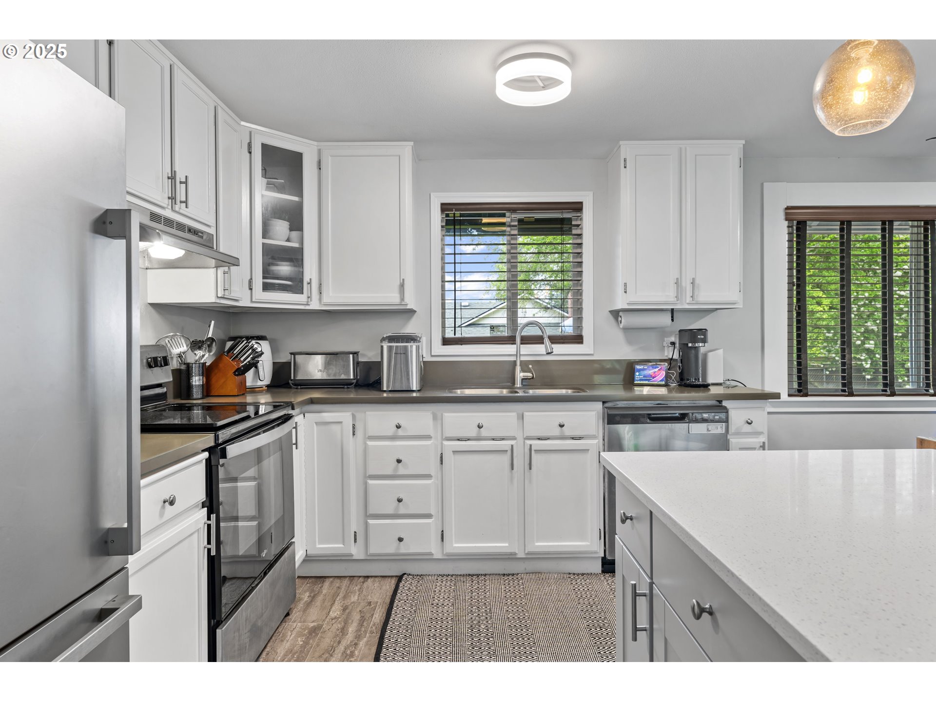 1245 Southeast 211th Avenue Gresham, OR 97030 - Photo 10 of 36 a kitchen with stainless steel appliances granite countertop a sink window and cabinets