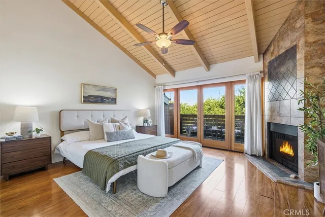 a bedroom with a large bed and a fireplace