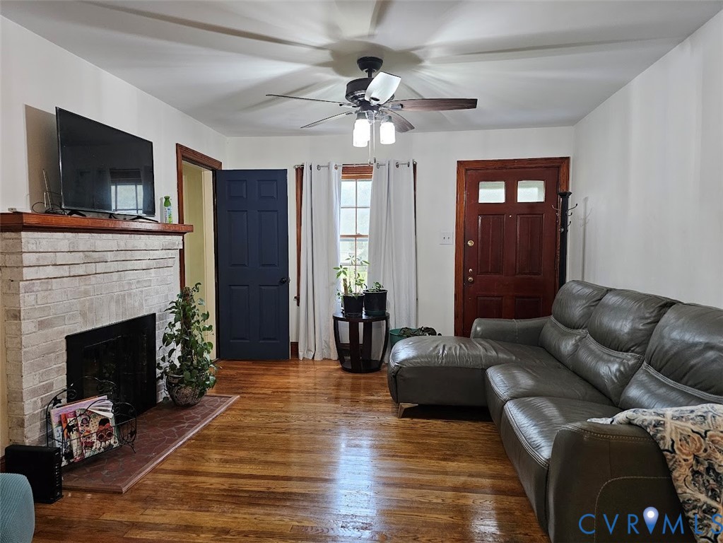 3200 Manorcrest Road Richmond, VA 23234 - Photo 3 of 23 Warm wood-finish flooring, a brick fireplace with