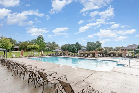 a view of a house with backyard porch and sitting area