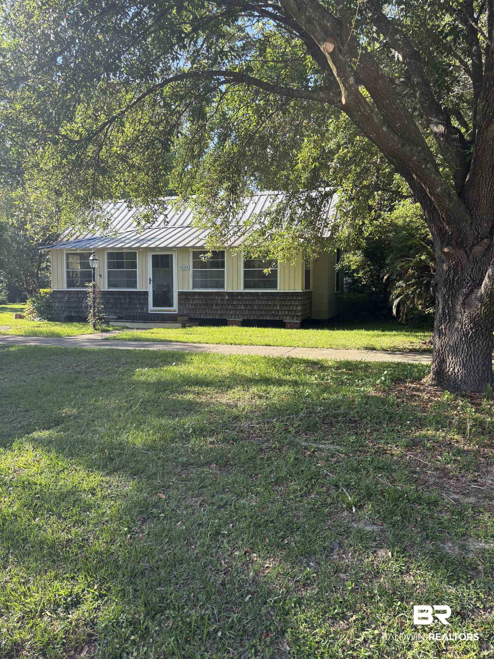 216 West Orange Avenue Foley, AL 36535 - Photo 1 of 37 View of front facade with a front lawn