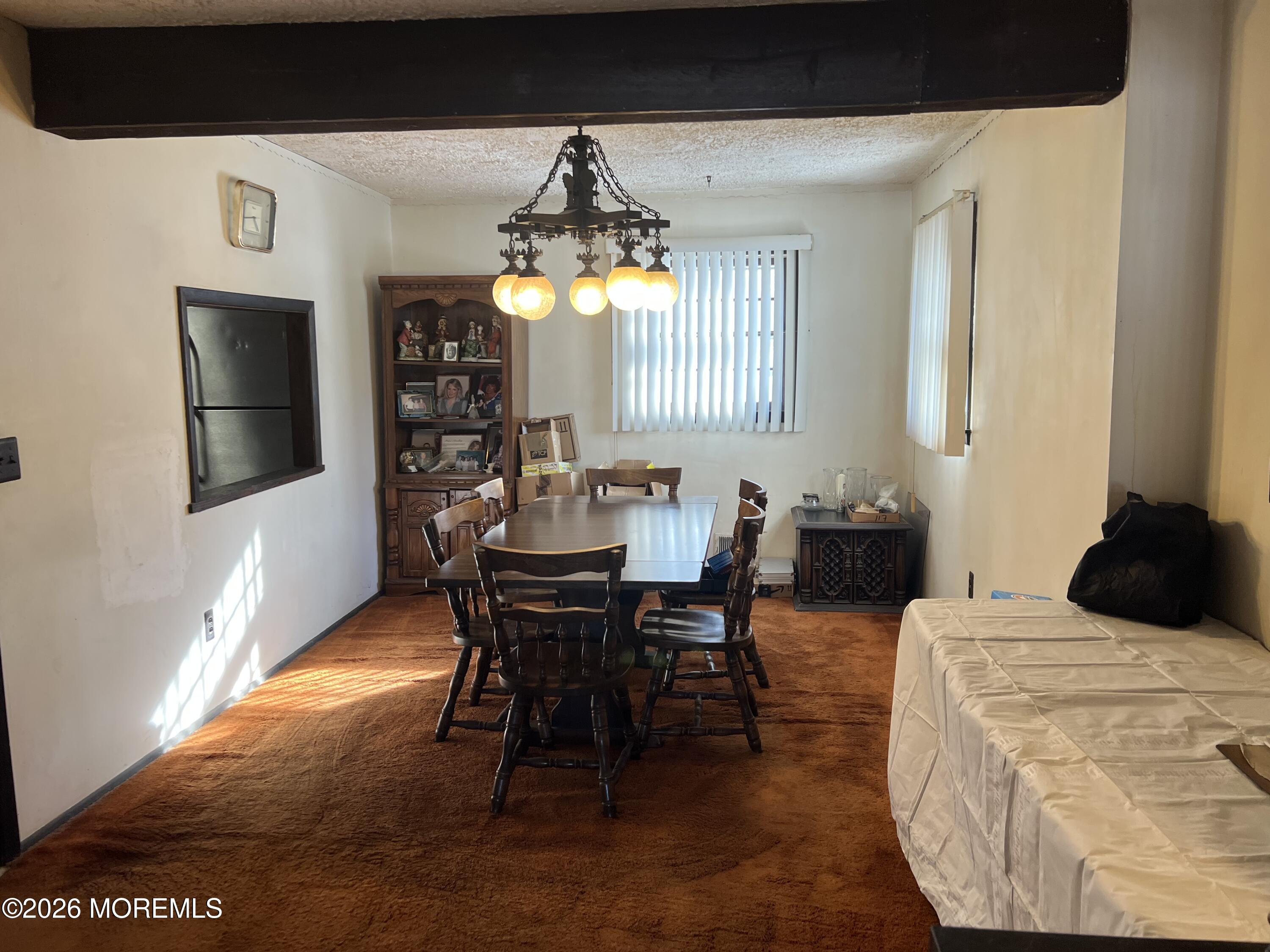571 Hopping Road Belford, NJ 07718 - Photo 25 of 29 a bedroom with furniture and a chandelier