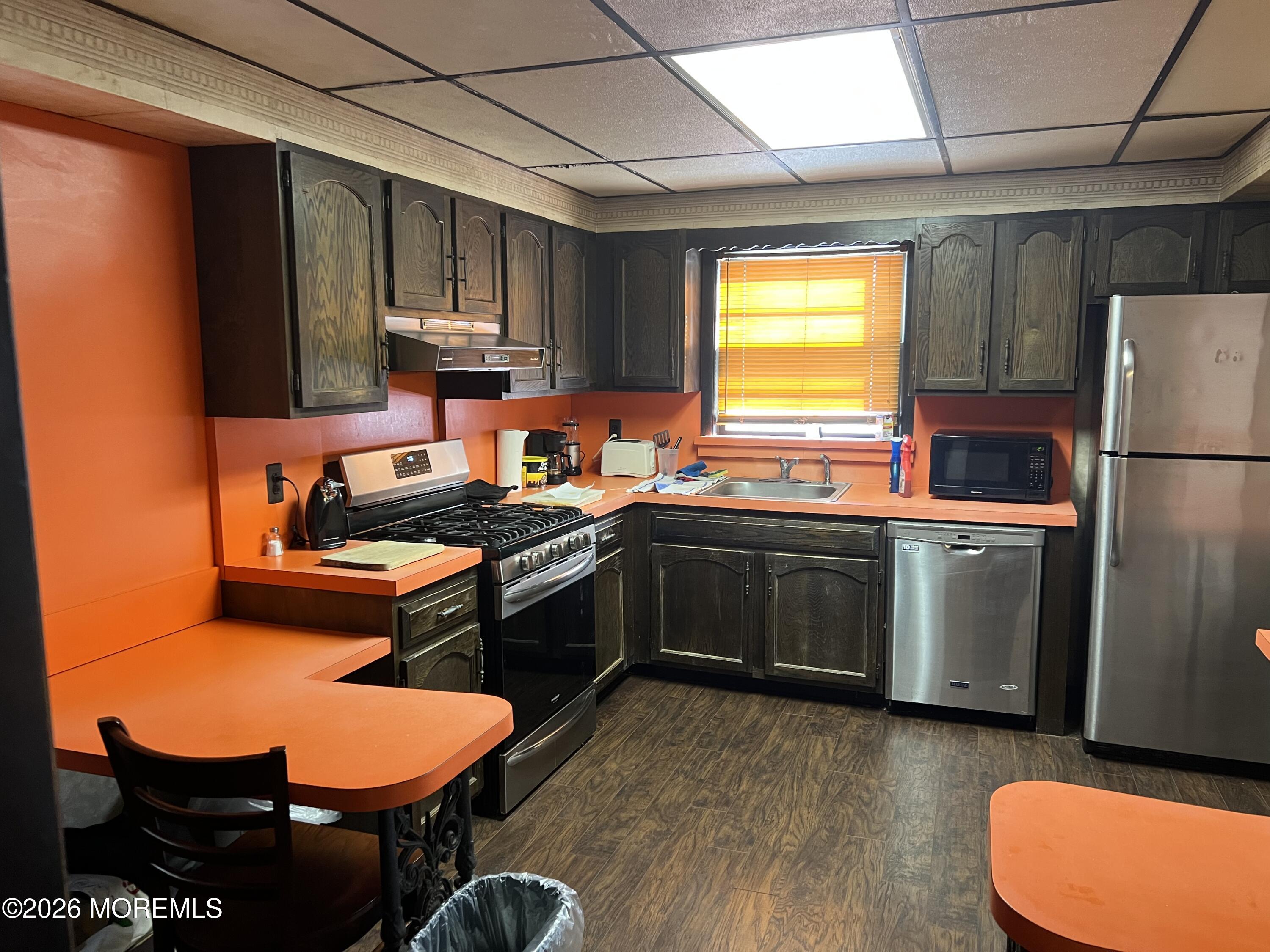 571 Hopping Road Belford, NJ 07718 - Photo 7 of 29 a kitchen with a sink appliances and cabinets