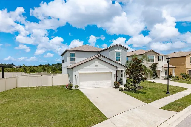 a front view of a house with a garden and yard