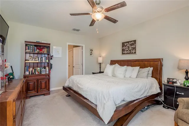 a bedroom with a bed furniture and book shelf