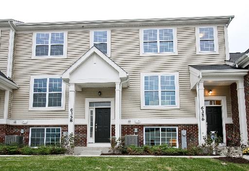 10346 Kerry Ridge Court, Unit 26 Chicago Ridge, IL 60415 - Photo 1 of 13 a front view of a house with yard and windows
