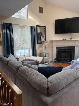 a living room with furniture fireplace and flat screen tv