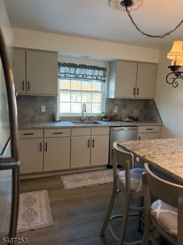 a kitchen with a table chairs sink and cabinets