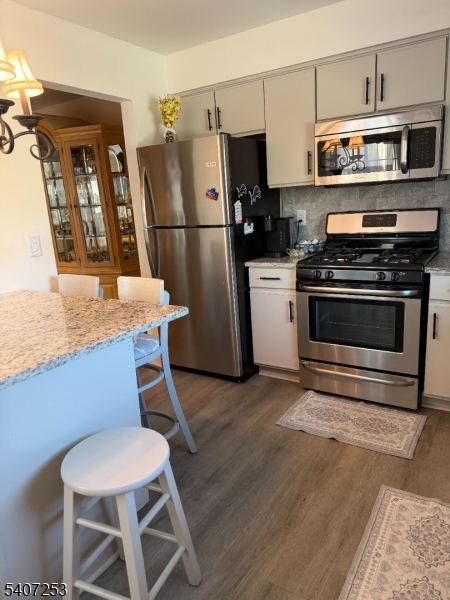 15 Rhea Run, Unit 15 Newton, NJ 07860 - Photo 3 of 19 a kitchen with stainless steel appliances a stove a refrigerator and a dining table