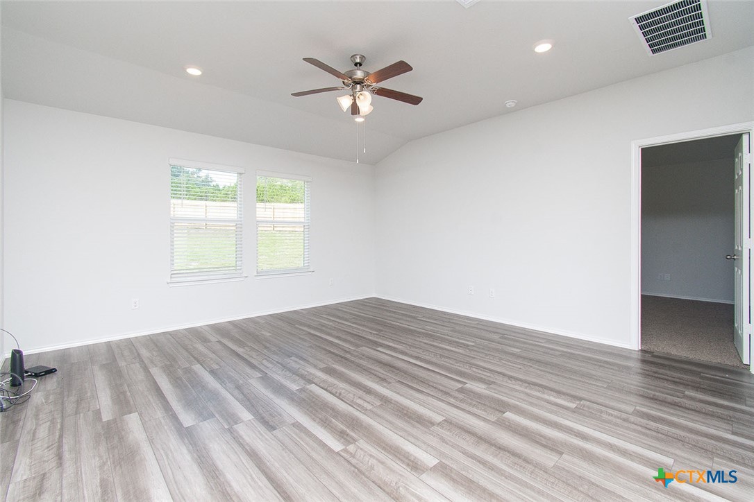 1717 Cedrus Drive Belton, TX 76513 - Photo 3 of 23 a view of an empty room with wooden floor and a window