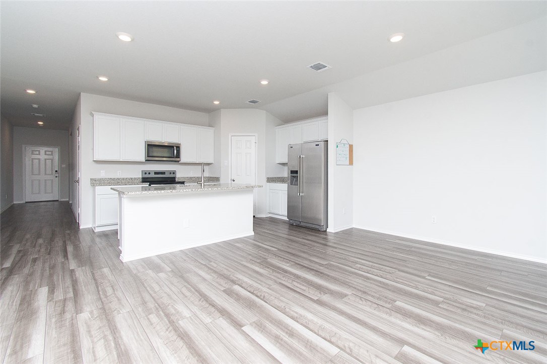 1717 Cedrus Drive Belton, TX 76513 - Photo 4 of 23 a kitchen with stainless steel appliances a refrigerator sink and microwave