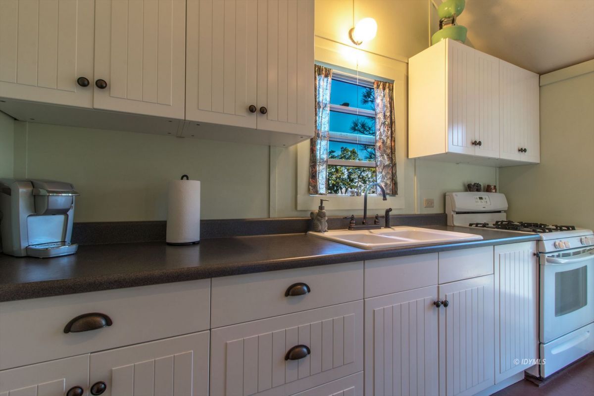 52830 Cedar Crest Drive Pine Cove, CA 92549 - Photo 11 of 31 a kitchen with stainless steel appliances granite countertop a sink and a white cabinets