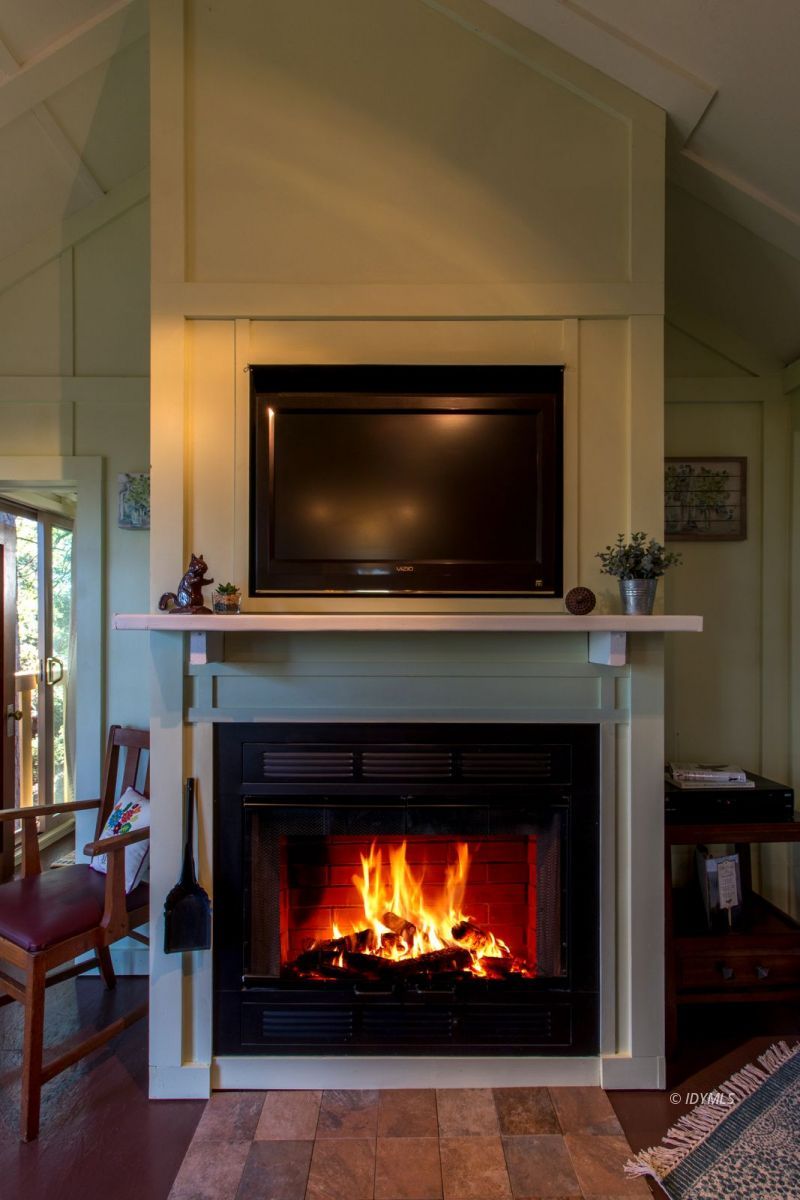 52830 Cedar Crest Drive Pine Cove, CA 92549 - Photo 17 of 31 a living room with a fireplace and a flat screen tv