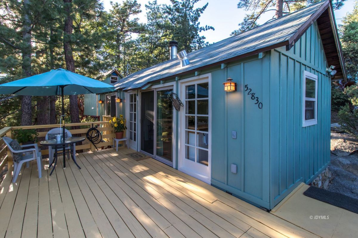 52830 Cedar Crest Drive Pine Cove, CA 92549 - Photo 8 of 31 a view of patio with table and chairs under an umbrella with wooden floor